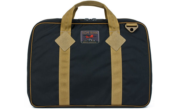 Founder's Briefcase in Black 420 Parapack with Coyote (tan) trim and a logo at the top-middle.